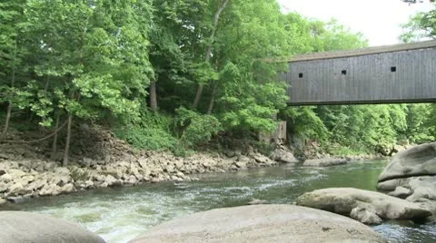 Covered bridge going over a slow moving river (2 of 2) Stock-Footage 10772580
