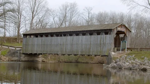 Covered bridge over the river in Lowell, Michigan. 4k60p Stock Footage 128850677