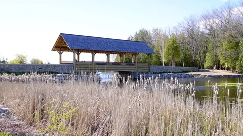Covered bridge over river water on summer day Slide shot Vidéo 79407063