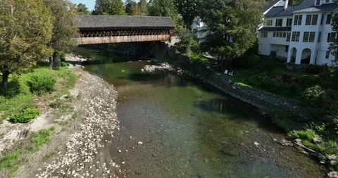 Covered Bridge over Small Stream Drone Aerial Woodstock Vermont USA Stock Footage 277122275