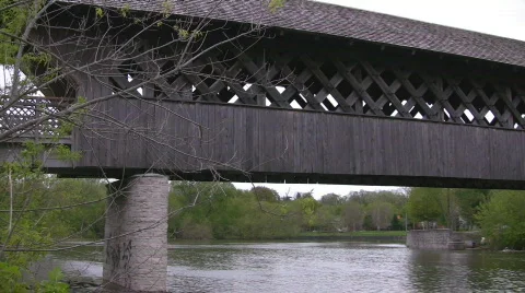 Covered bridge pan from the river below Stock Footage 487343