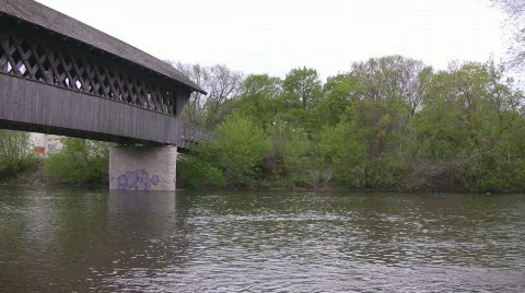 Covered bridge pan from the river below Stock Footage 487557