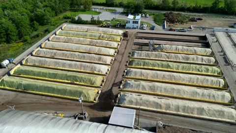 Covered heaps of compost, organic fertilizer for agricultural use; aerial Stock Footage 208306498
