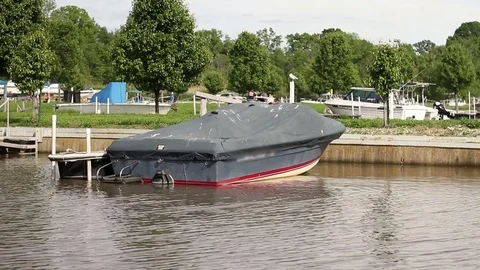 Covered old broken speedboat docked in marina Stock Footage 76101730