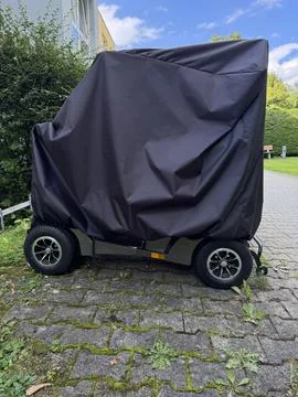 A covered trailer rests on a charming cobblestone pathway, displaying an Stock Photos