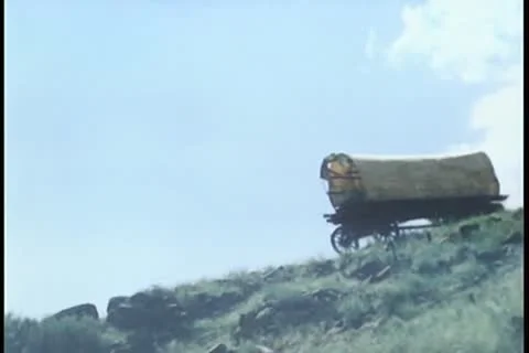 Covered wagon falling down hill Stock Footage 11351897