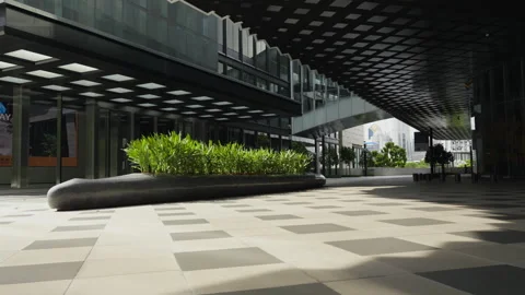 Covered walkway with geometric ceiling design outside One Bangkok mall Stock Footage 345957154
