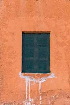 Covered window on an orange colored wall in Morocco countryside (Tinghir area Stock Photos