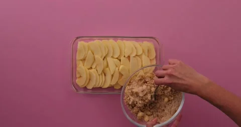 Covering apples with crumble mixture Stock Footage 132208939