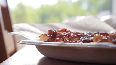 Covering bacon stips with plate Stock Footage 68655699