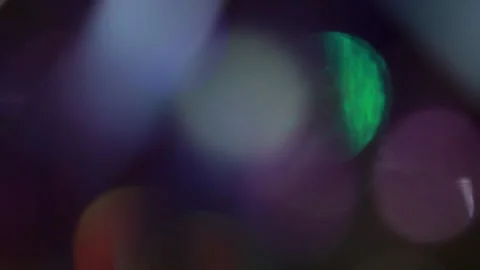 Covering delicate flames with twinkling colored bokeh 動画素材 309596826