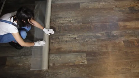 Covering the floor with foil Stock Footage 101862459