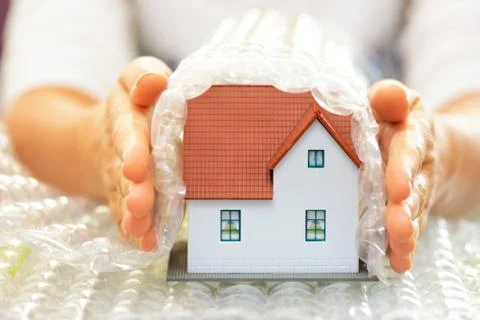 Covering a model house with bubble wrap- house protection or insurance concept Stock-Fotos