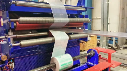 Covering polycarbonate sheet with packing foil at factory Stock Footage 234319577
