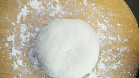 Covering raw bread overhead Stock Footage 121120067