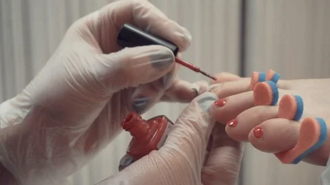 Covering toenails with polish Stock Footage 87825352