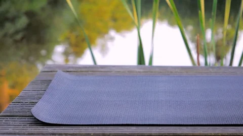 Covering a yoga mat before practicing slow motion. Stock Footage 77766009