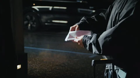 Covert Exchange Close-Up: Suitcase and Thick Envelope Passed Between Figures Stockbeeldmateriaal 335474540