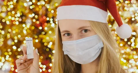 COVID-19 antigen test negative result. Young woman in Christmas hat of Santa Video stock 166992029