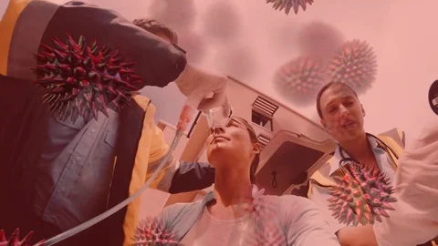 Covid-19 cells spreading over paramedics putting on an oxygen mask on a woman in Stock Footage 128307112