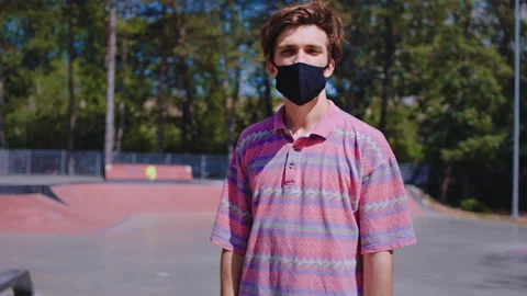 Covid-19 concept closeup to the camera charismatic guy with a protective mask Stock Footage 134405889