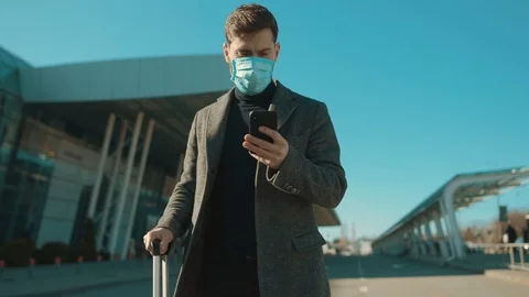 COVID-19 coronavirus infection man wearing Protective Face Mask use phone coughs Stock Footage