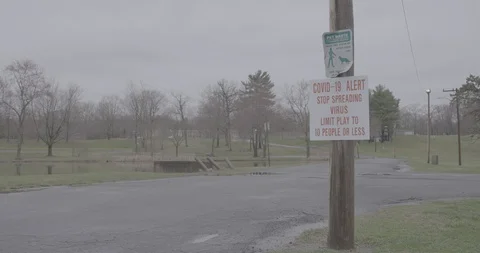 Covid-19 Coronavirus Warning Sign at Public Park Stock Footage 128386341