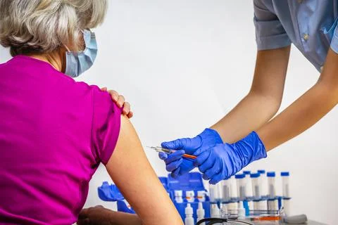 COVID-19 immunization. Vaccinating the elderly. Stock Photos