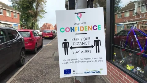 COVID-19 'Keep Your Distance' Public Signage in UK Town Stock Footage 140613383