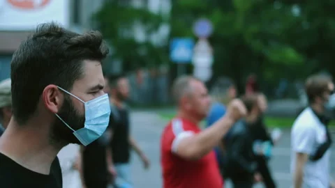 Covid-19 lockdown restrictions strike, masked man on opposition rally picket. Stock Footage 160984172