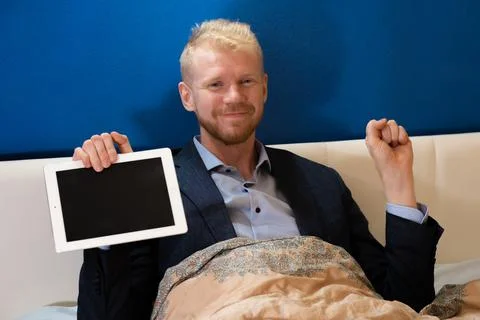 Covid-19 lockdown, work at home from bed Stock Photos