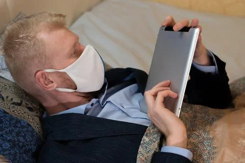 Covid-19 lockdown, work at home from bed Stock Photos