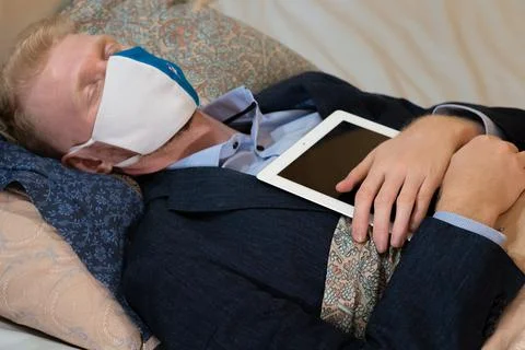Covid-19 lockdown, work at home from bed Stock Photos