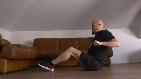 Covid 19, lockdown - young atlethic man training at home to keep fit Stockbeeldmateriaal 128184765