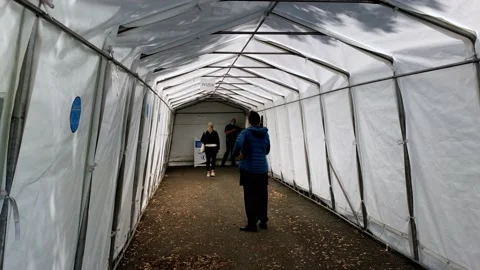Covid 19 makeshift vaccination hub, Person waiting in a tunnel for their Stock Footage 161236294