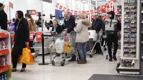 Covid-19 panic - Large queue at Sainsbury's supermarket London Stock Footage