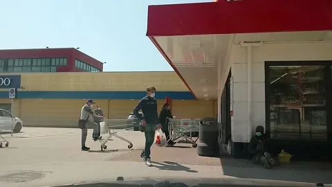 Covid-19 people queuing to enter the supermarket Stock Footage 140460522