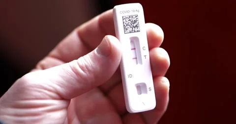 Covid 19 positive antigen test with two red lines control and test in Stock Footage 169560298