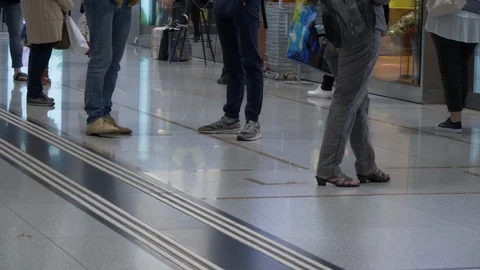 COVID-19 queue up before store with social distancing marker - moving Stock Footage 129779928