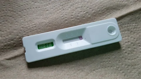 Covid-19 rapid antigen test kit ATK video showing result of infected positive Stock Footage 207932443