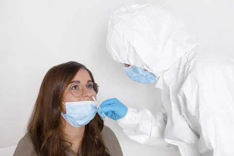 Covid 19 test. Laboratory worker wearing personal protective equipment testin Stock Photos