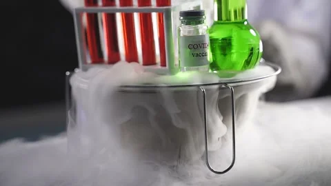 Covid-19 test in tubes bottles and green liquid in smoke Stock Footage 145221768