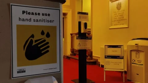 COVID-19 TESTING CENTRE IN LONDON UK SIGN SAYS PLEASE USE SANITIZER 4K Stock Footage 145424994