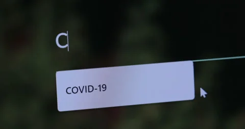 "COVID-19" typing into search engine on computer Screen Stock Footage 127493888