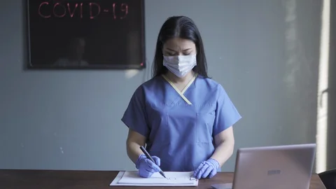 Covid 19 warning sign in doctors hands. Stock Footage 130054941