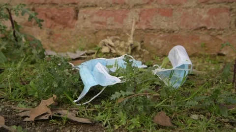 Covid garbage. Pollution mask. Used disposable mask. Coronavirus Garbage Video stock 148432638