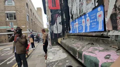 COVID GRAFFITI SAYS PLEASE KEEP BEING SWEET BRICK LANE 4K Stock Footage 143122341