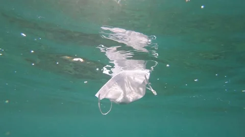 Covid Mask on Ocean Surface.  Stock Footage 137484218
