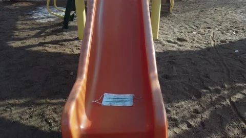 Covid mask on playground slide Stock Footage 150074978