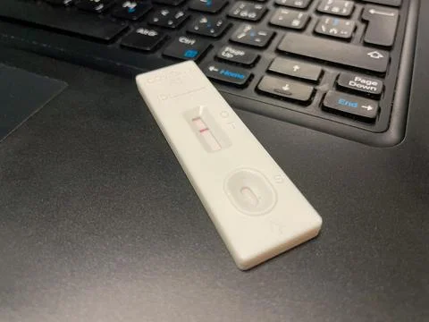 COVID negative antigen test in work on laptop Stock Photos